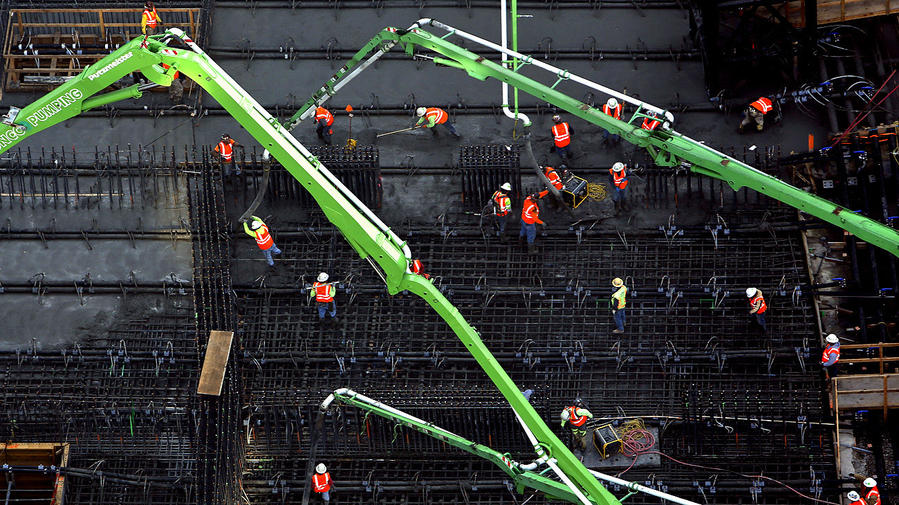 builders in the work, concrete pumps, constructing a building